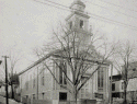 Universalist Church (c. 1840) on Main Street from a 1920 photo (Woonsocket Library Historical Collection)